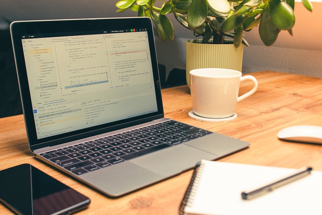 Laptop computer with legal document pages and a cup of coffee on a desk