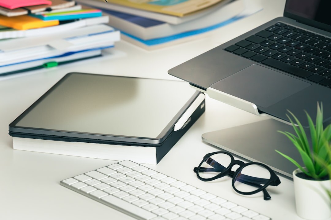 Bright modern office workspace with a laptop and folders on a desk