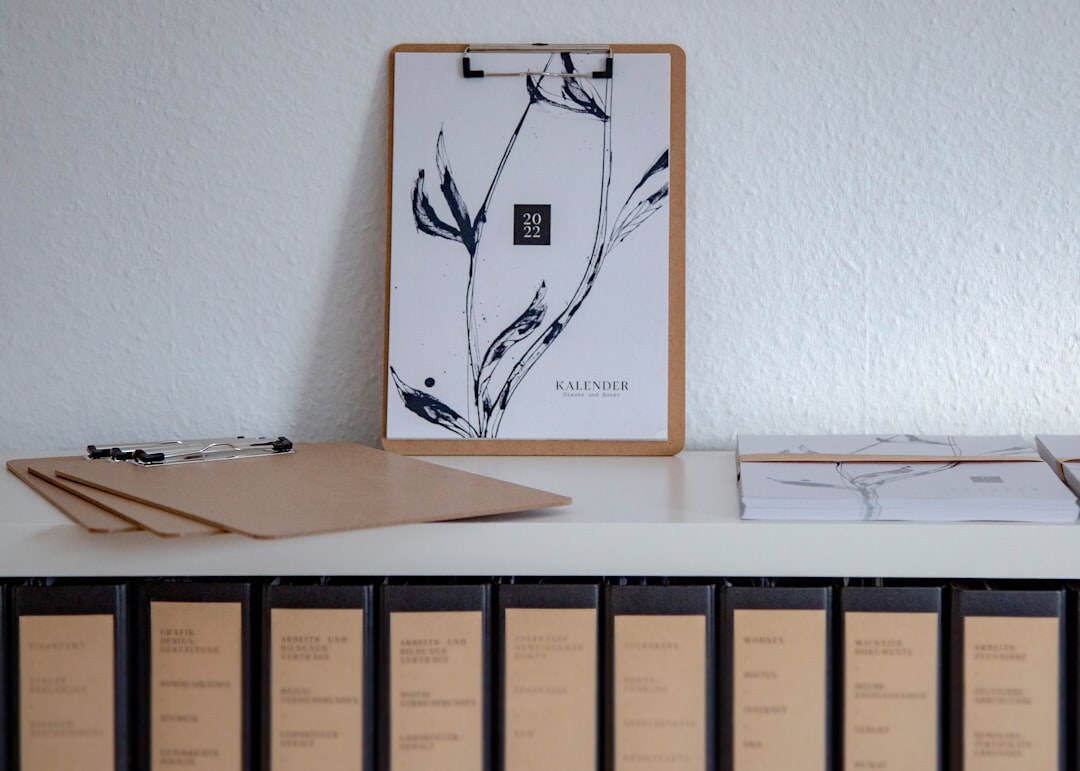 Wooden desk with legal documents, a pen and a folder in a bright office